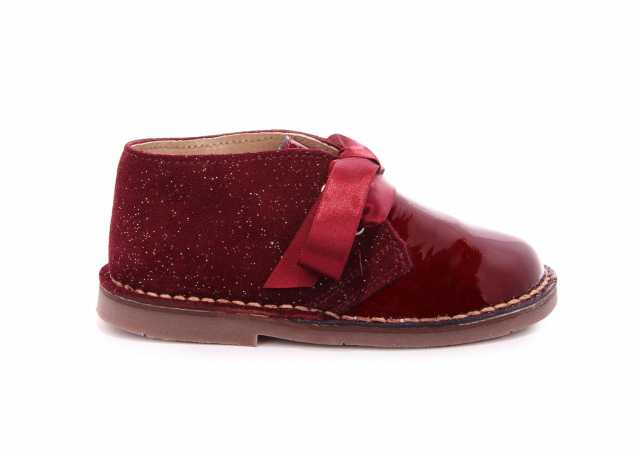 BOTA NIÑA EN ANTE GLITTER Y CHAROL CON LAZO